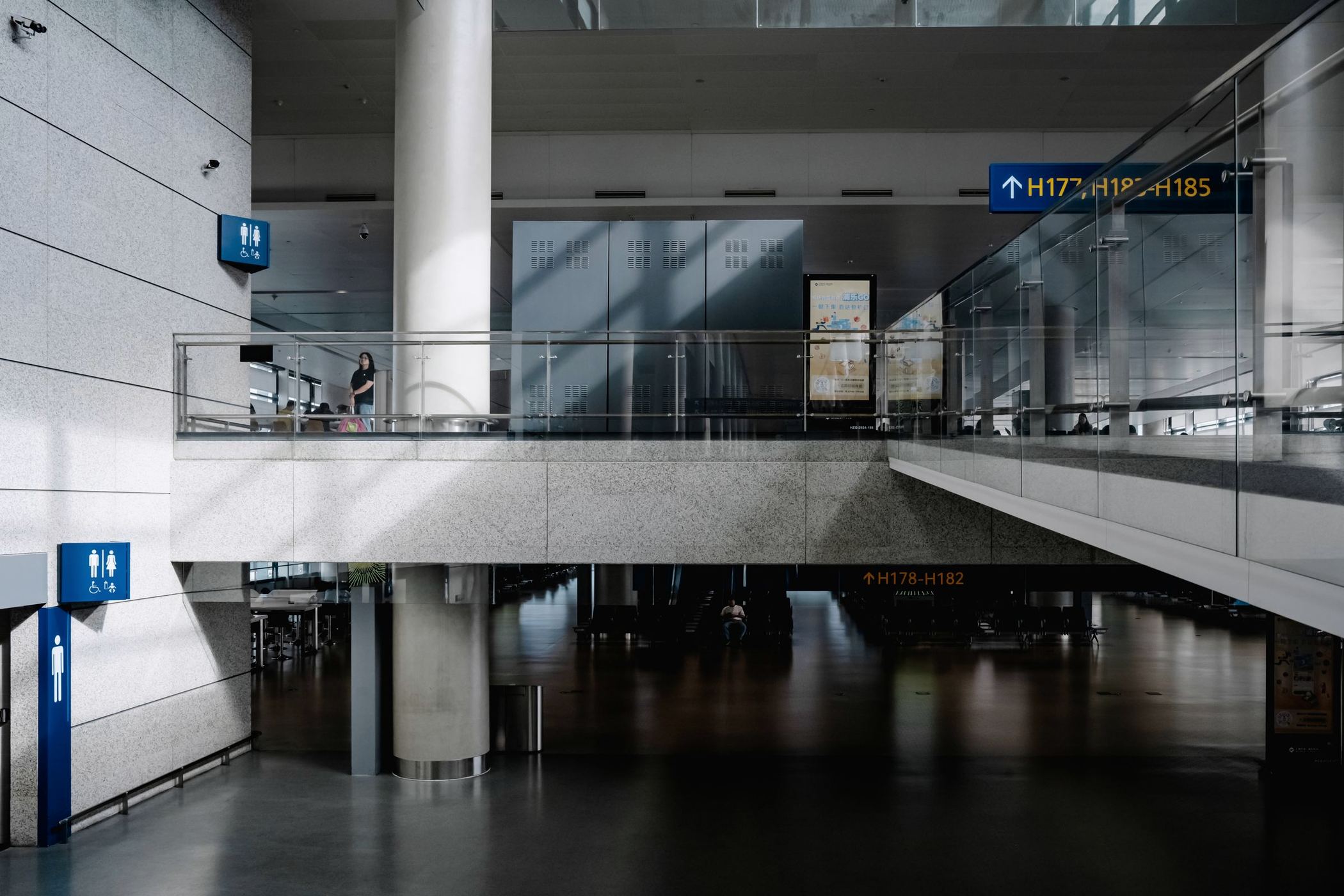 A modern airport terminal concourse with travellers